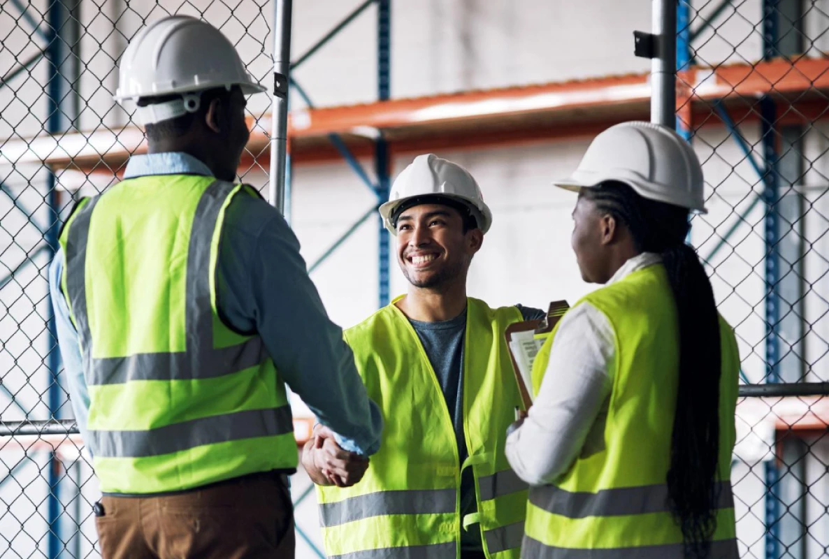 Workers in high-visibility vests inside a distribution warehouse